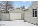 Detached garage with white doors provides ample parking and storage space in this charming residence at 7135 W 24Th Ave, Lakewood, CO 80214