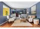 Bright living room featuring stylish decor, hardwood floors, and a glimpse into an adjacent cozy fireplace at 7135 W 24Th Ave, Lakewood, CO 80214