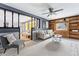 Stylish living room with decorative chair, wood paneling and an open layout to the Gathering room at 7135 W 24Th Ave, Lakewood, CO 80214