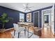 Cozy office with hardwood floors, a modern desk, and an accent wall for a touch of color at 7135 W 24Th Ave, Lakewood, CO 80214