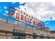 Exterior shot of Edgewater Public Market with a large red sign and various storefronts at 7135 W 24Th Ave, Lakewood, CO 80214