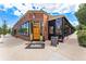 Exterior of Sloan's Tap & Burger showcasing its brick facade, wood door, and outdoor seating area at 7135 W 24Th Ave, Lakewood, CO 80214