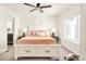 Inviting bedroom with a ceiling fan, natural light, and ensuite bathroom entrance at 1168 S Reed Way, Lakewood, CO 80232