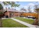 Well maintained backyard with a dining area, seating area with a fire pit, and lush green grass at 3085 W 36Th Ave, Denver, CO 80211