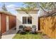Cozy backyard area with a small building featuring decorative chairs and a flower box under the window at 3085 W 36Th Ave, Denver, CO 80211