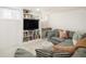 Comfortable basement living area features a large sectional sofa, stylish cushions, and built in bookcase at 3085 W 36Th Ave, Denver, CO 80211