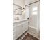 Elegant bathroom featuring a white vanity, subway tile, and a combination tub and shower, creating a clean and bright space at 3085 W 36Th Ave, Denver, CO 80211