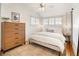 Serene bedroom featuring a plush bed, natural light from windows, and a stylish dresser for ample storage at 3085 W 36Th Ave, Denver, CO 80211