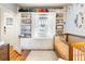 Charming Bedroom with built-in bookshelves, a cozy window seat, and a wooden crib, perfect for a baby's room at 3085 W 36Th Ave, Denver, CO 80211
