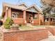 Charming brick home with a covered porch, beautiful yard, and inviting curb appeal at 3085 W 36Th Ave, Denver, CO 80211