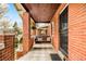 Inviting covered front porch with a porch swing and brick accents at 3085 W 36Th Ave, Denver, CO 80211