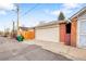 View of the detached garage and alleyway with exterior trash cans at 3085 W 36Th Ave, Denver, CO 80211