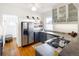 Modern kitchen with stainless steel appliances, sleek blue cabinetry, concrete countertops, and hardwood floors throughout at 3085 W 36Th Ave, Denver, CO 80211
