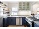 Modern kitchen with navy cabinets, stainless steel appliances, and stylish countertops at 3085 W 36Th Ave, Denver, CO 80211