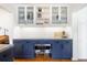 Charming kitchen showcasing stylish blue cabinets, glass-front shelving, subway tile backsplash, and concrete countertop at 3085 W 36Th Ave, Denver, CO 80211