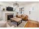 Cozy living room with a brick fireplace, hardwood floors, and ample natural light at 3085 W 36Th Ave, Denver, CO 80211
