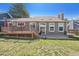 Backyard featuring a deck, well-maintained lawn, and a view of the home's exterior at 5429 S Waco St, Centennial, CO 80015