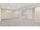Spacious finished basement with neutral carpet, recessed lighting, and multiple entryways at 5429 S Waco St, Centennial, CO 80015