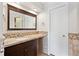 Bathroom with stone countertops, stylish tiling, and dark wood cabinets at 5429 S Waco St, Centennial, CO 80015