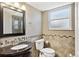 Charming bathroom with a granite vanity, decorative wall accent, updated fixtures and large window at 5429 S Waco St, Centennial, CO 80015