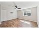 The bedroom features a ceiling fan, hardwood floors, baseboard trim, and a large window at 5429 S Waco St, Centennial, CO 80015
