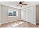 The bedroom features a large window, wood-look flooring, neutral walls, and a ceiling fan at 5429 S Waco St, Centennial, CO 80015