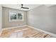 This bedroom features beautiful hardwood floors, neutral walls, white baseboards, a ceiling fan, and a window at 5429 S Waco St, Centennial, CO 80015