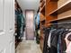 Walk-in closet with custom shelving, hanging rods, and a central cabinet for ample storage at 5429 S Waco St, Centennial, CO 80015