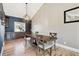 Elegant dining area featuring a modern light fixture, built-in cabinets, and hardwood flooring at 5429 S Waco St, Centennial, CO 80015