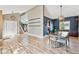 Open-concept dining area with hardwood floors, modern lighting, and views into the kitchen at 5429 S Waco St, Centennial, CO 80015