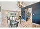 Stylish dining area with modern light fixture, hardwood floors, and an open view of the kitchen at 5429 S Waco St, Centennial, CO 80015