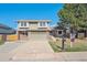 Charming two-story home with a well-maintained lawn, attached garage, and mature trees at 5429 S Waco St, Centennial, CO 80015
