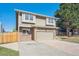 Lovely home featuring brick accents, an attached garage, and a well-manicured front yard at 5429 S Waco St, Centennial, CO 80015