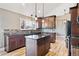 Well-lit kitchen featuring stainless appliances, granite countertops, tile backsplash, and hardwood flooring at 5429 S Waco St, Centennial, CO 80015