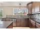 Kitchen featuring stainless appliances, granite countertops, tile backsplash, and a view to the backyard at 5429 S Waco St, Centennial, CO 80015