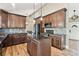Bright kitchen featuring stainless appliances, granite countertops, tile backsplash, and hardwood flooring at 5429 S Waco St, Centennial, CO 80015