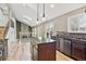 Bright kitchen featuring stainless appliances, granite countertops, kitchen island, and vaulted ceilings at 5429 S Waco St, Centennial, CO 80015