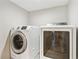 Bright laundry area with a front load washing machine and a white dryer at 5429 S Waco St, Centennial, CO 80015