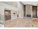Spacious living room with stone fireplace, wet bar, hardwood floors, and an open concept at 5429 S Waco St, Centennial, CO 80015