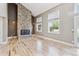 Living room with hardwood floors, a floor to ceiling stone fireplace, and lots of natural light at 5429 S Waco St, Centennial, CO 80015