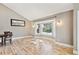 Bright living room featuring hardwood floors, a bay window, and modern wall sconces at 5429 S Waco St, Centennial, CO 80015