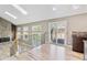 Open-concept living room with hardwood floors, stone fireplace, skylights, and access to backyard deck at 5429 S Waco St, Centennial, CO 80015