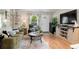 Cozy living room featuring a sofa, coffee table, and large TV at 1811 S Quebec Way # 134, Denver, CO 80231