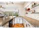 Close up view of bar with stone counter and wine shelves, with views of the deck through the windows at 9506 S Deer Creek Canyon Rd, Littleton, CO 80127