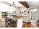 Unique bar with stone counters, modern lighting, and a view of the deck and into the bathroom at 9506 S Deer Creek Canyon Rd, Littleton, CO 80127