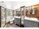 Modern bathroom with dual vanities, sleek fixtures, and a glass-enclosed shower at 9506 S Deer Creek Canyon Rd, Littleton, CO 80127