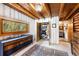Bedroom featuring a large window, ample closet space, and wood beam ceilings at 9506 S Deer Creek Canyon Rd, Littleton, CO 80127