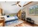 Charming bedroom featuring wood ceiling, hardwood floors, natural light from multiple windows, and nice decor at 9506 S Deer Creek Canyon Rd, Littleton, CO 80127