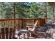 Relaxing deck space with seating, surrounded by trees, creating a serene and peaceful outdoor retreat at 9506 S Deer Creek Canyon Rd, Littleton, CO 80127