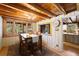 Inviting dining room featuring wood table, chairs, and view of the kitchen and backyard at 9506 S Deer Creek Canyon Rd, Littleton, CO 80127